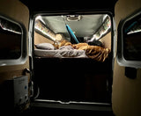 Relax inside this cozy rv rental camper van. Enjoy a comfortable bed, ambient lighting, and amenities like a hammock.