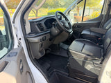 Driver's view in a clean RV rental van, featuring black leather seats, steering wheel, and dashboard, ready for your trip.