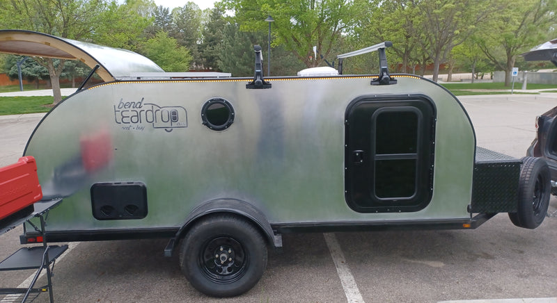 Explore the outdoors with this silver Bend Teardrop camper trailer, perfect for rv rental adventures with Thule racks & gear. — photo 2
