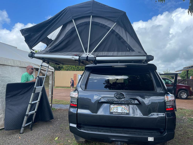 Hawaii RV rental: dark SUV with deployed rooftop tent and ladder, ready for camping adventures. — photo 11