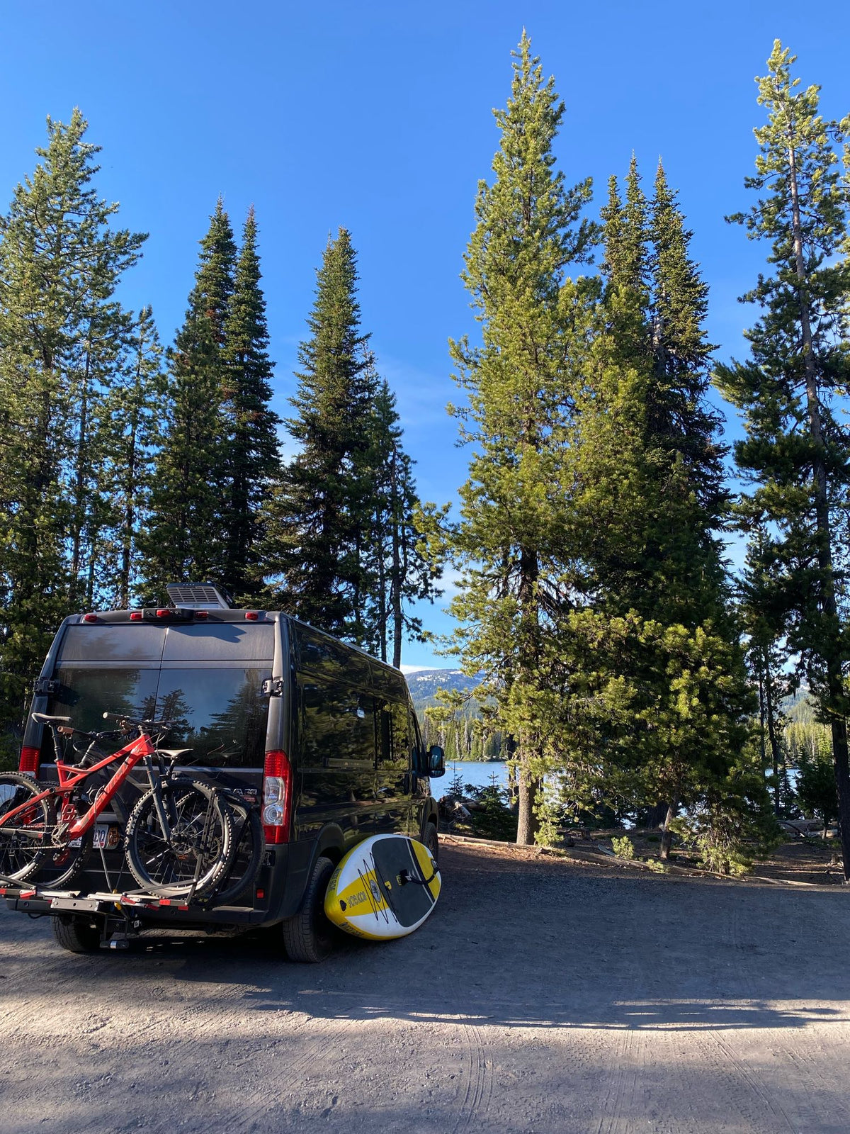  against rocky mountains.|Scenic RV rental van parked for camping. The grey ProMaster is open — photo 10