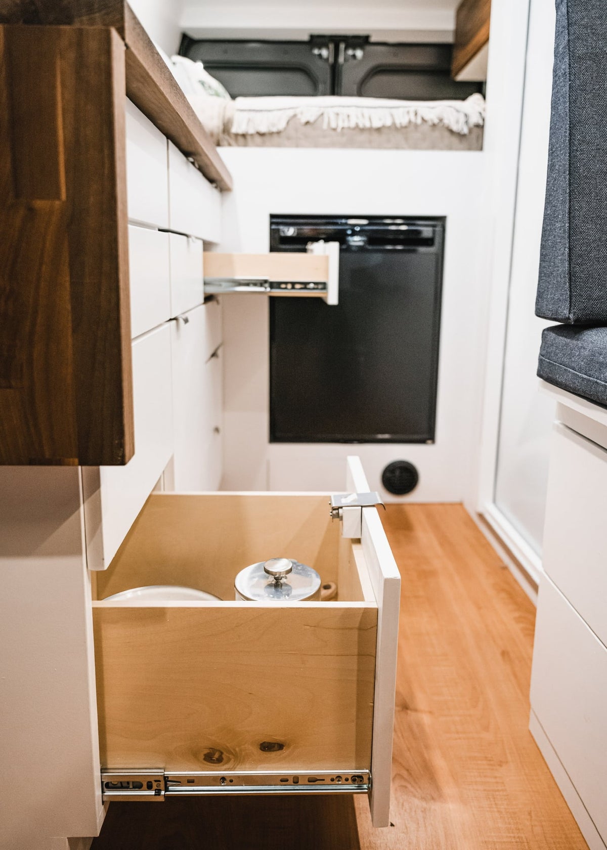  offering mobile hospitality services.|Inside this RV rental camper van: a cozy raised bed — photo 10