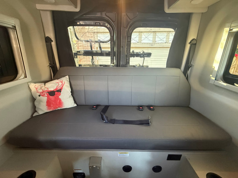  parked amidst stunning red rock scenery.|This grey RV rental van — photo 1