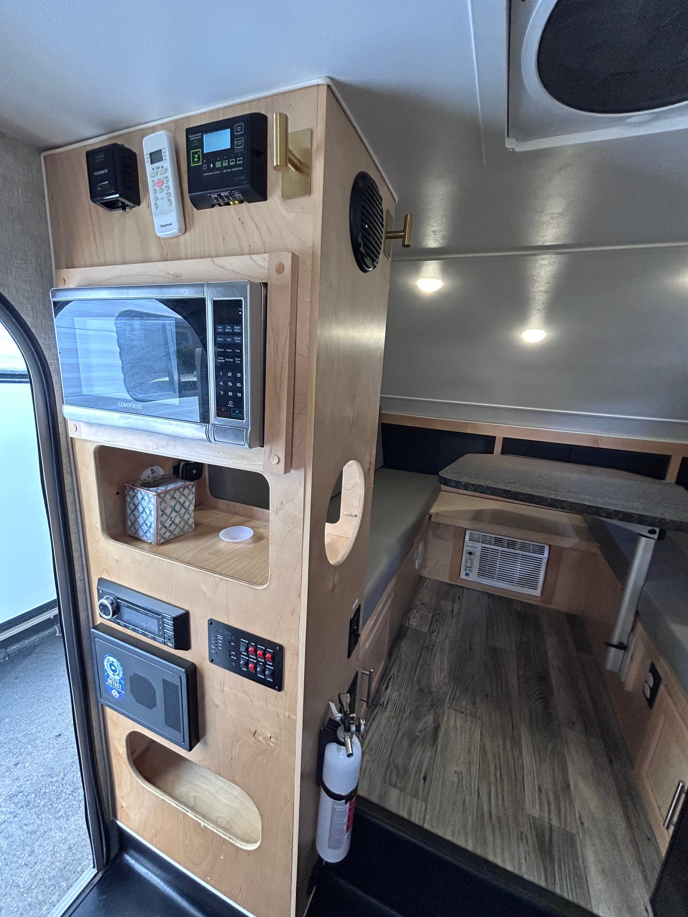 Compact RV rental: microwave, AC, stereo, solar controls & seating. Essential amenities for travel enjoyment.