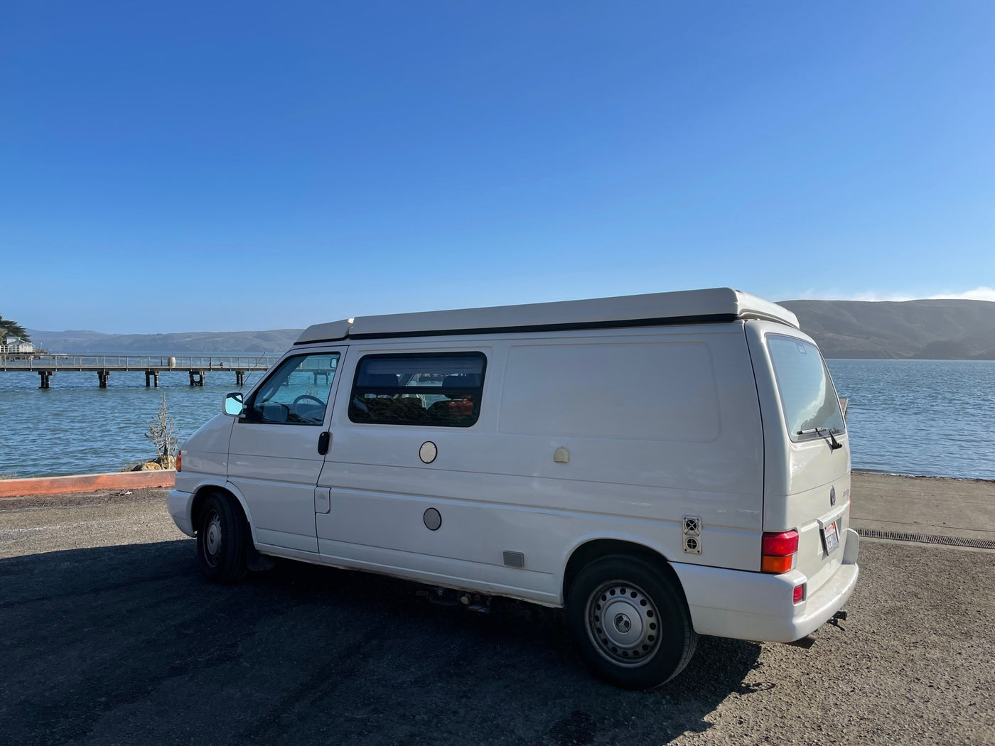  and fridge.|Comfortable RV rental interior with a deployed bed — photo 8