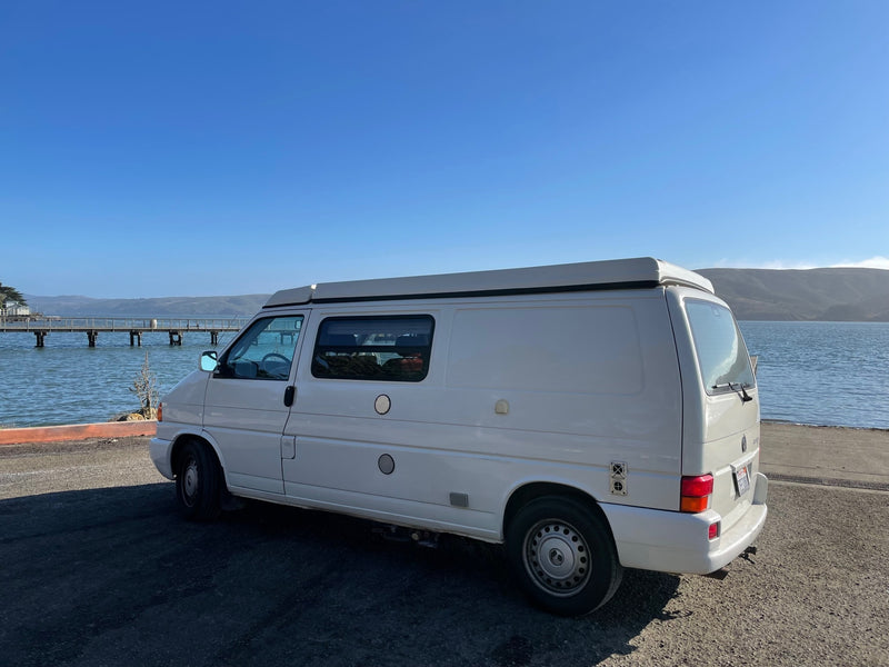  and fridge.|Comfortable RV rental interior with a deployed bed — photo 8
