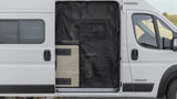 Open white Winnebago camper van RV rental. Side door reveals a black mesh screen & light wood interior, ready for travel.