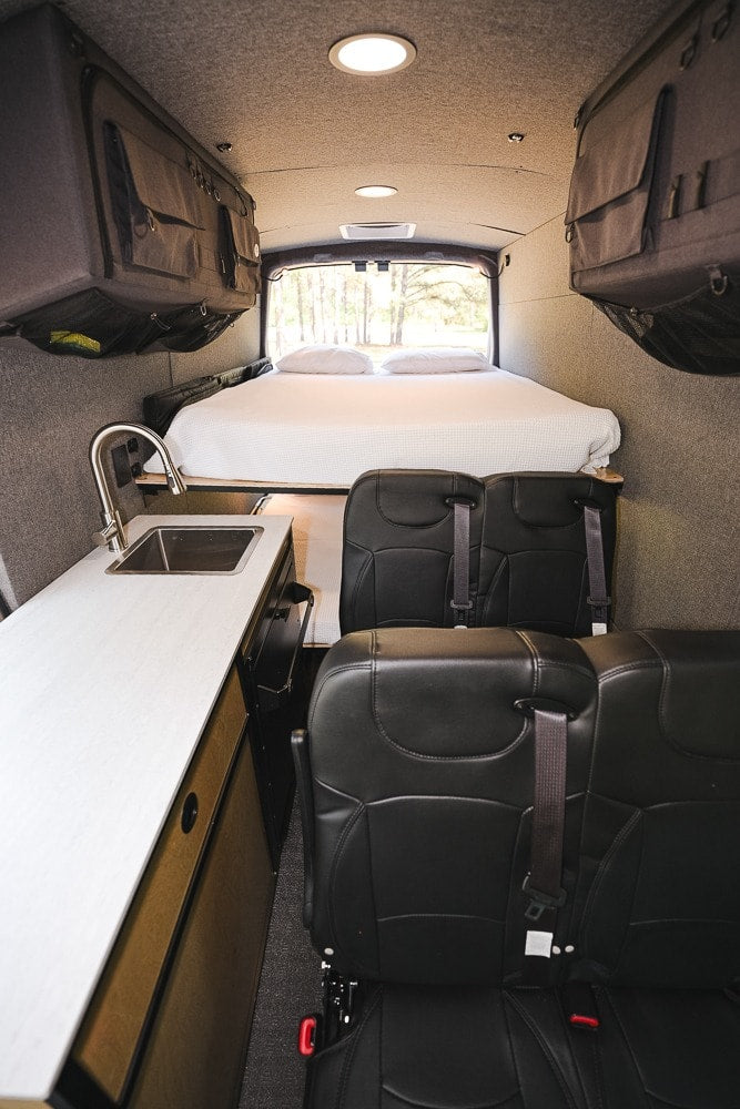  creating an efficient mobile living space.|Spacious RV rental camper van interior showcasing a kitchen counter — photo 15
