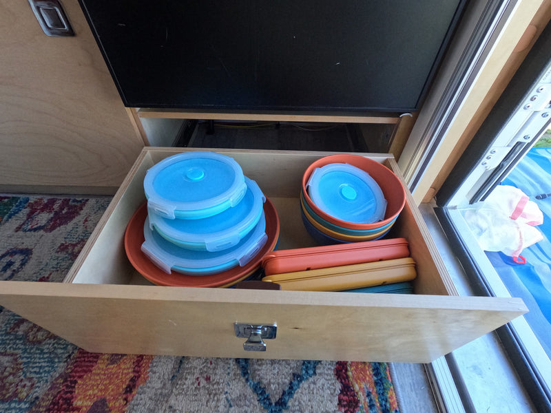 RV rental: Open drawer with colorful, space-saving collapsible food containers, bowls, and utensil cases for organized travel. — photo 18