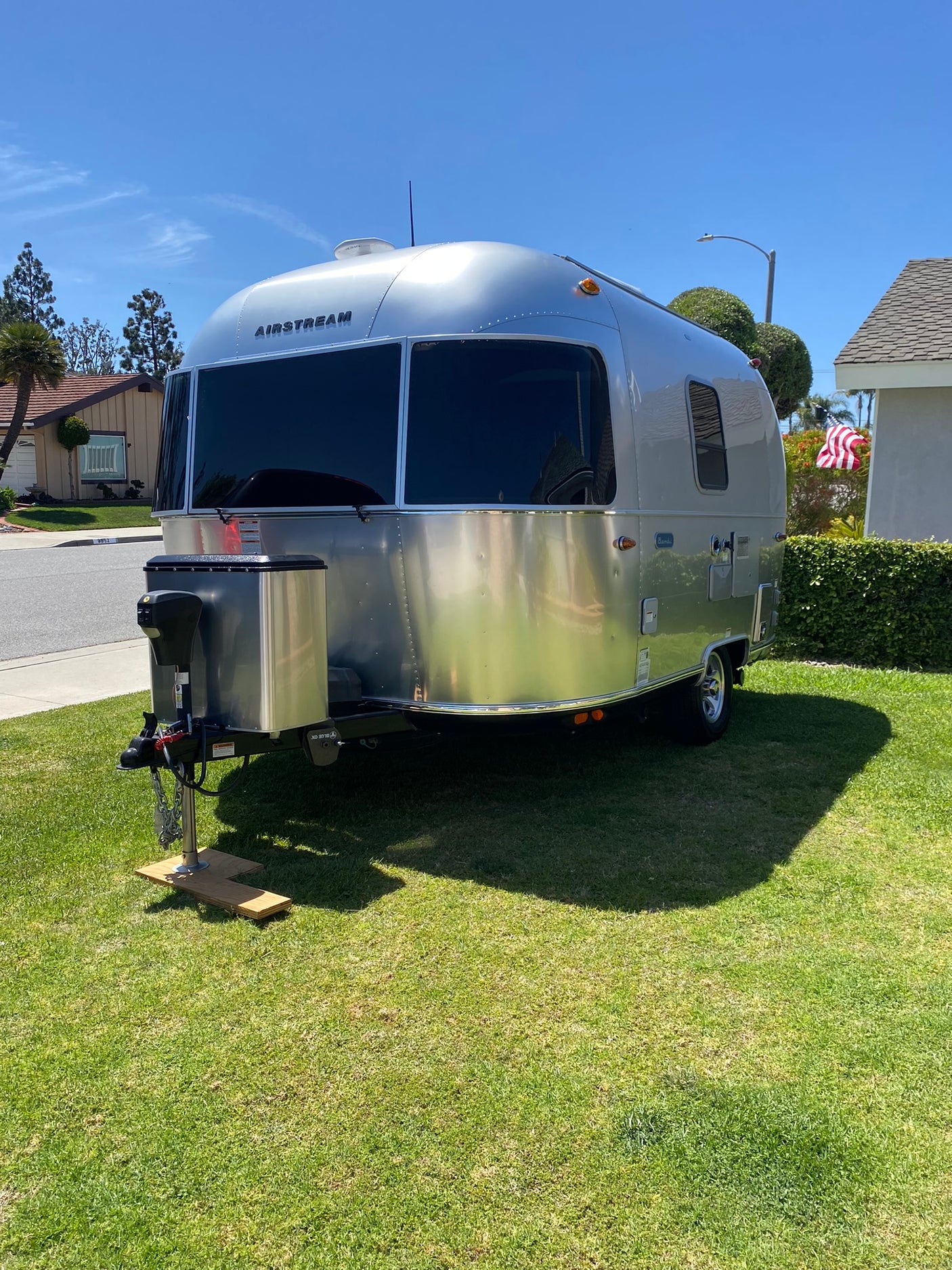 Experience an Airstream travel trailer for your next RV rental. Iconic silver design on a sunny day.