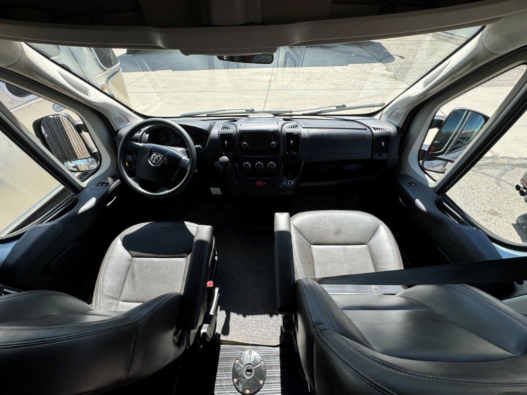  and warm wooden cabinets.|Step inside this RV rental! View of the spacious front cabin with steering wheel — photo 8