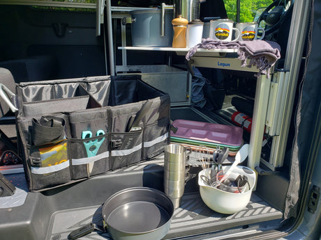 Compact RV rental kitchen setup with organized cooking gear, storage, and camping essentials.
