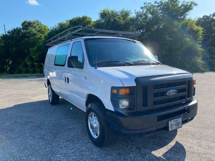  verdant field with distant hills under a partly cloudy sky.|Man relaxing in an RV rental