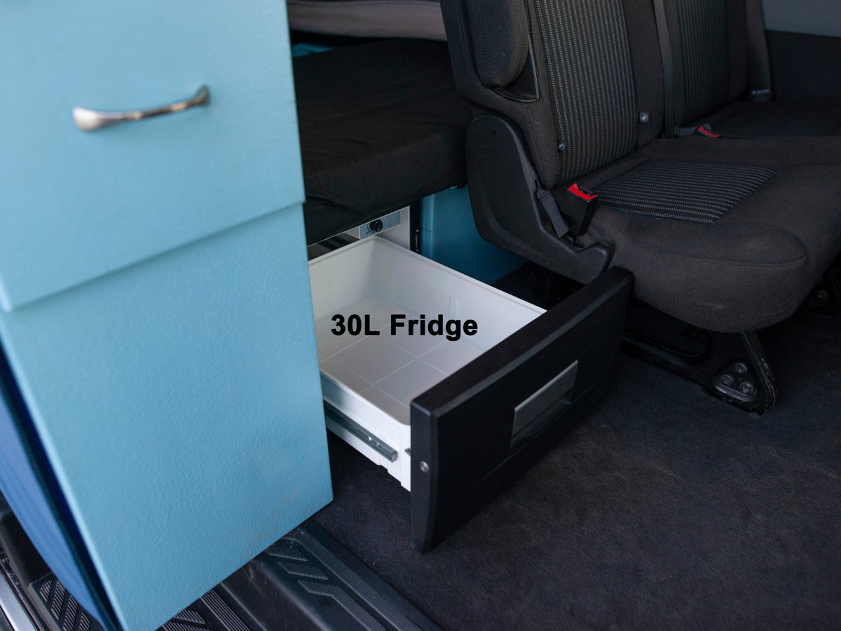  next to a small kitchenette with a sink.|RV rental rear storage box with lid open — photo 16