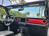 Jeep Wrangler RV rental interior with a vibrant red dash, open roof, & tropical views. Your adventure vehicle awaits!
