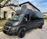 A dark gray Ram ProMaster camper van with a pop-top roof, ready for your next rv rental adventure.