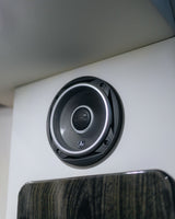 Close-up of a JL Audio speaker on a white panel in an RV rental, offering crisp audio.