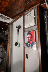 This RV rental boasts a stylish interior with a compact shower and Johnny Cash "I Walk the Line" art.