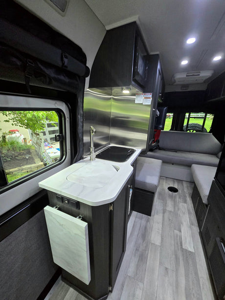  road ahead.|Modern RV rental interior: cozy grey lounge seating