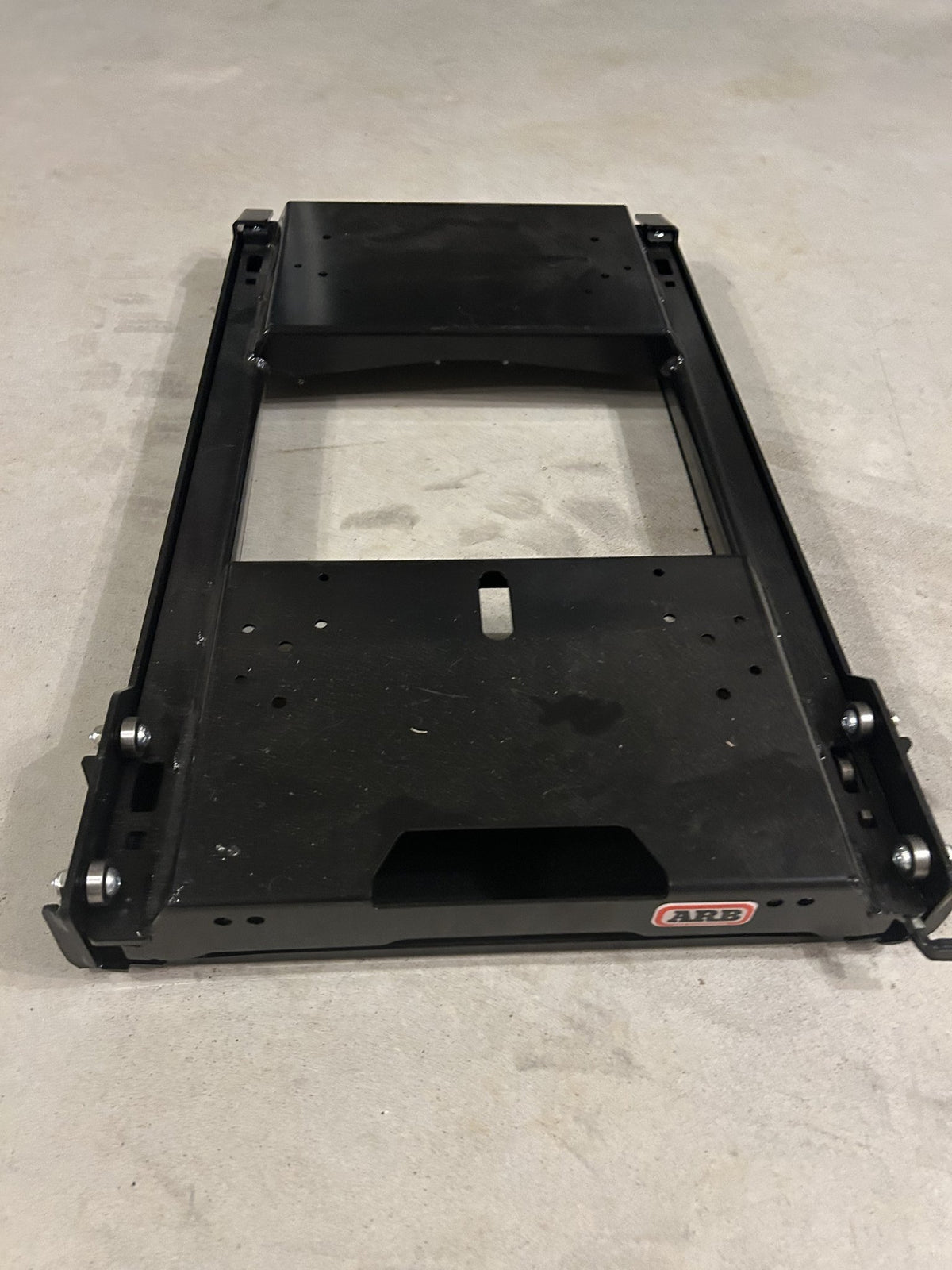 ARB Zero fridge slide at an angle, showing the ARB badge, side rails and tie-down slots — photo 2