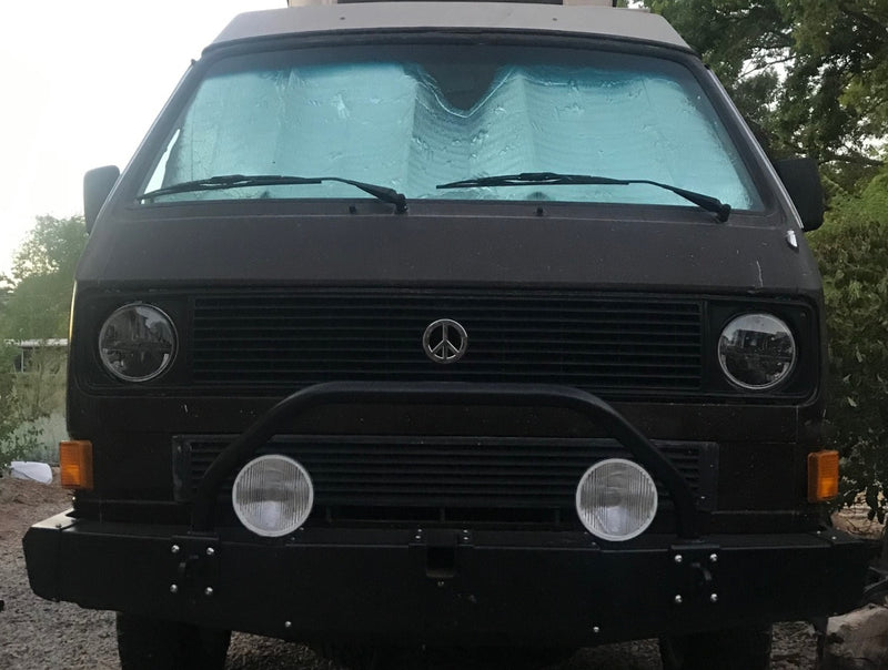  great for an rv rental adventure.|Front view of a dark VW Vanagon camper van with a sunshade — photo 2