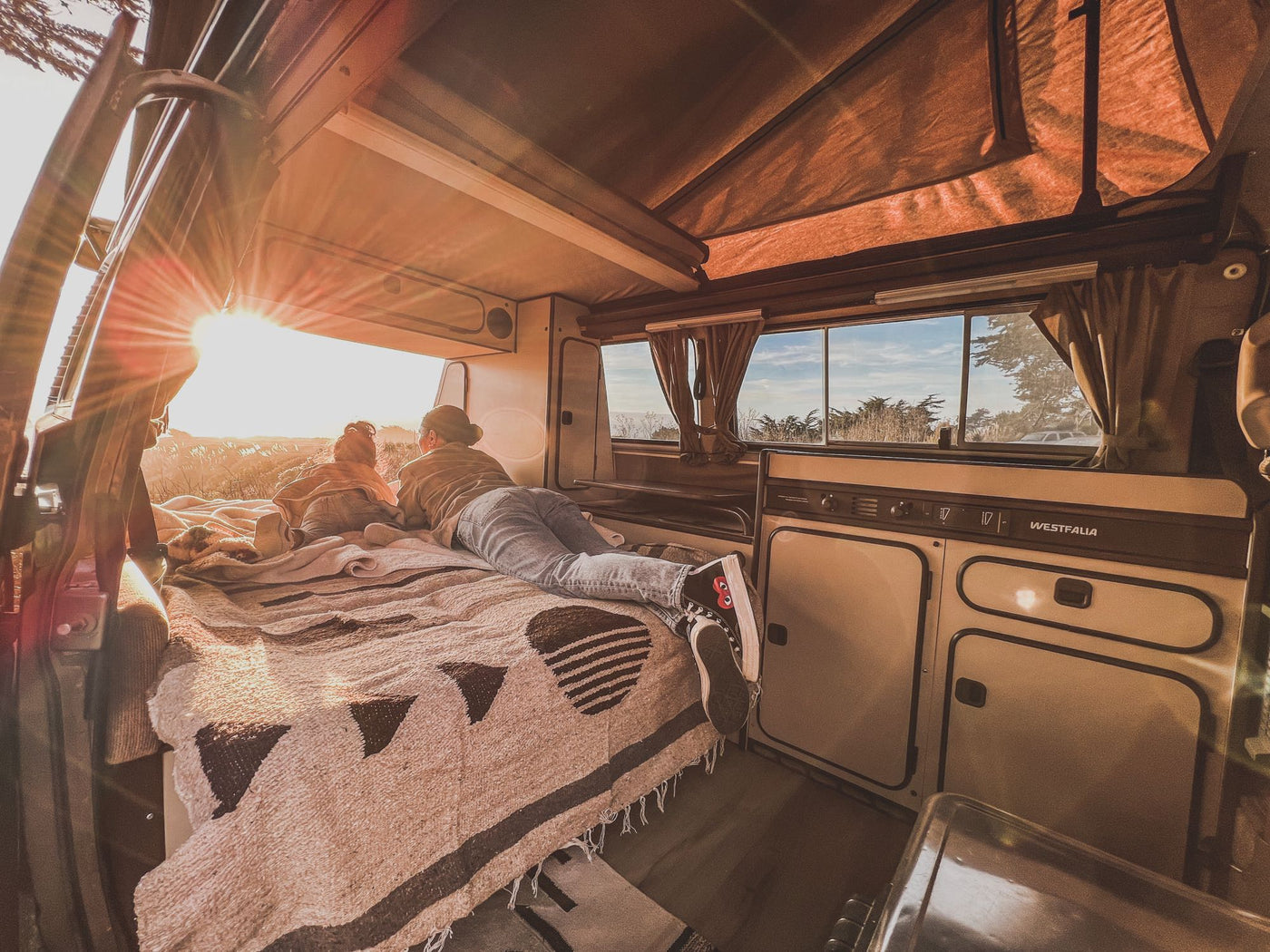  perfect for a scenic road trip.|A person relaxing on a bed in an RV rental camper van — photo 8