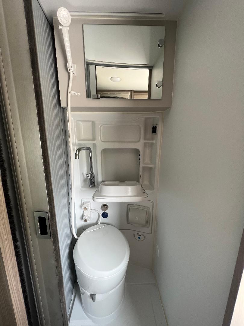  and smart storage solutions.|Modern rv rental camper van interior with convertible bench seating — photo 19