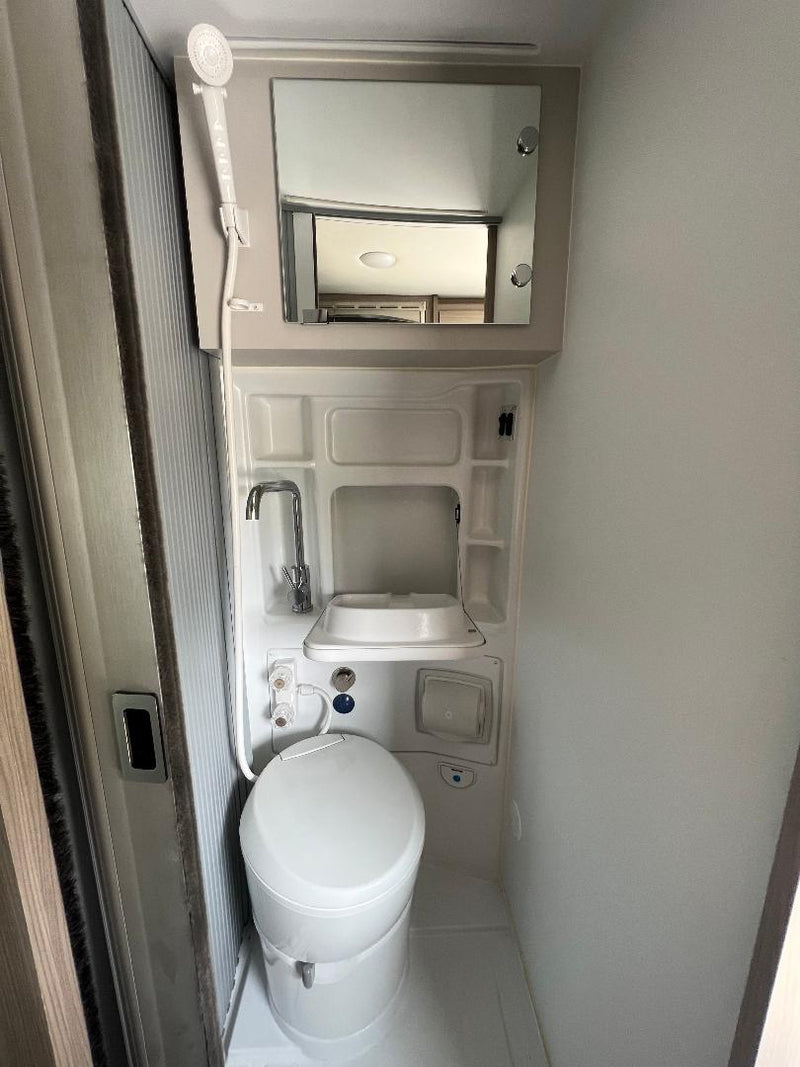  and smart storage solutions.|Modern rv rental camper van interior with convertible bench seating — photo 19