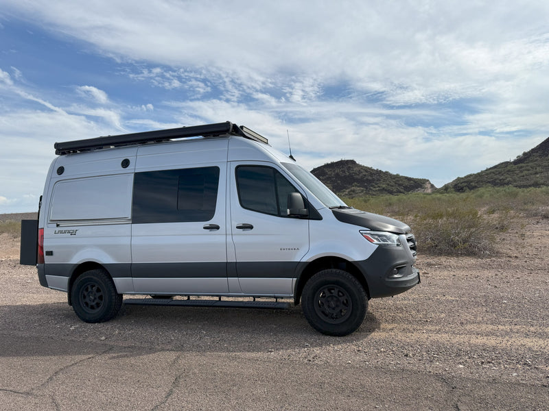  and a scenic window view of a desert mountain landscape.|Inside a comfortable **rv rental**: A compact kitchen with a fridge — photo 20