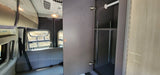 Inside an RV rental: a versatile closet with hanging rod & adjustable shelves, and a comfortable rear bench seat.