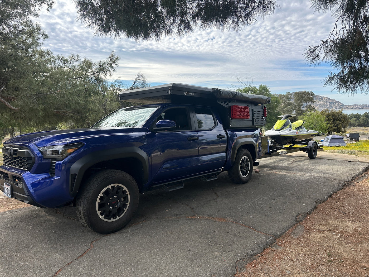  ideal for an adventurous RV rental experience.|Blue pickup truck with camper — photo 3