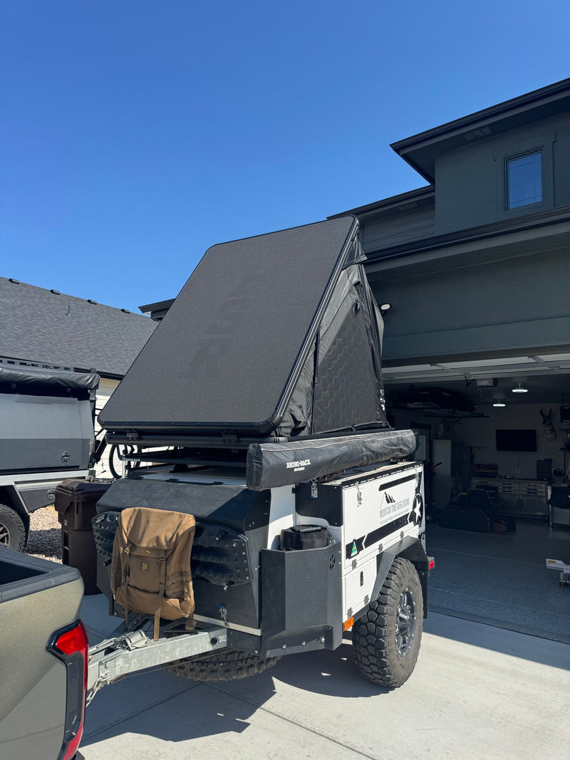 An "Mountain Time Overlanding" trailer with a rooftop tent and awning, ready for an RV rental adventure. — photo 12