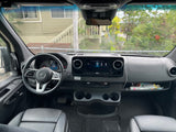  and stylish quilted passenger seats.|Cozy RV rental camper van interior featuring a large bed