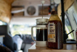 RV rental interior: French press coffee & Kirkland Oregon honey on a wooden counter. Great for road trip mornings.