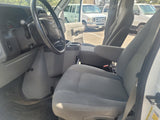Interior of a white Ford E-Series van, highlighting the driver's area. Great for an rv rental or utility use.