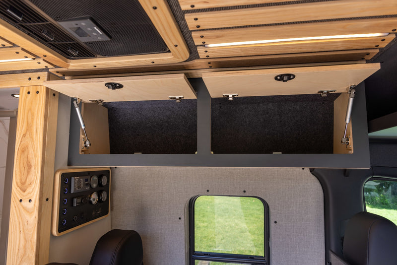  and a tiled shower with black fixtures.|Step inside this modern RV rental! Features a sleek kitchen — photo 4