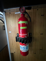 RV rental safety: A charged First Alert fire extinguisher, inspected 5-1-23, mounted and ready for emergencies.