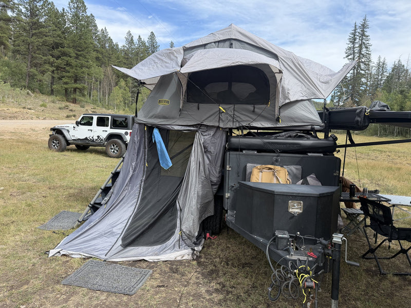 Opposite-side view with the annex door unzipped and rolled back, showing the mesh panel, the interior floor space of the annex and the tent mattress visible through the upper window — photo 3