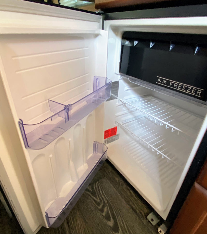  reveals a stunning sandy beach & clear ocean view.|A spacious RV rental van — photo 12