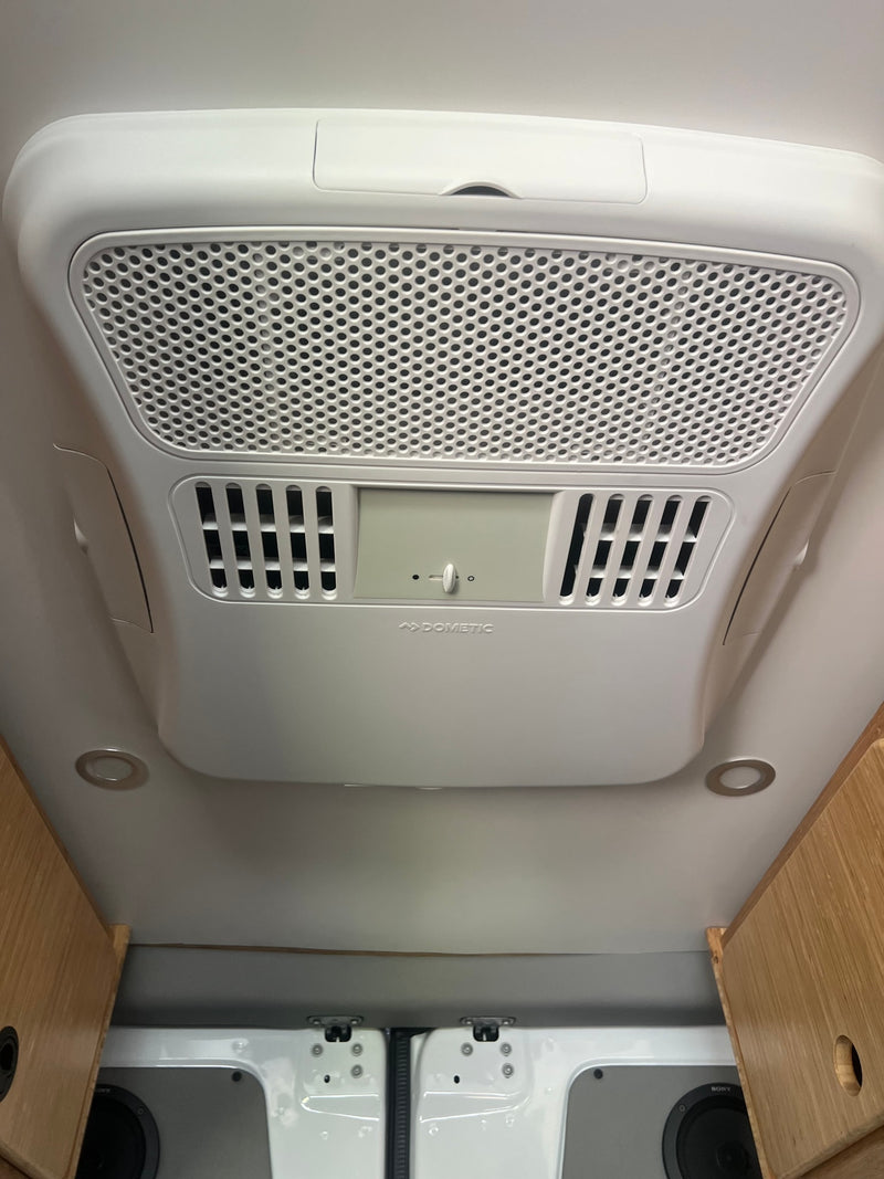 Overhead Dometic climate control unit with air vents & lights in an RV rental, ensuring comfort. — photo 15