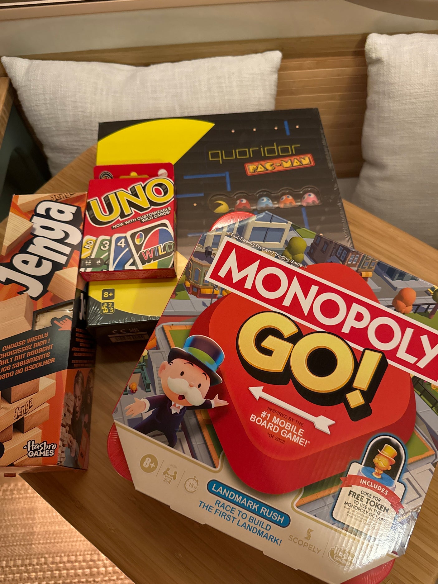 Essential board games for an RV rental getaway: Jenga, UNO, Monopoly Go!, and Quoridor Pac-Man.