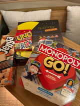 Essential board games for an RV rental getaway: Jenga, UNO, Monopoly Go!, and Quoridor Pac-Man.
