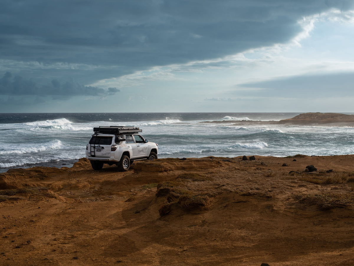  offering direct ocean access and nature views.|Aerial view: A white SUV with a rooftop tent — photo 6