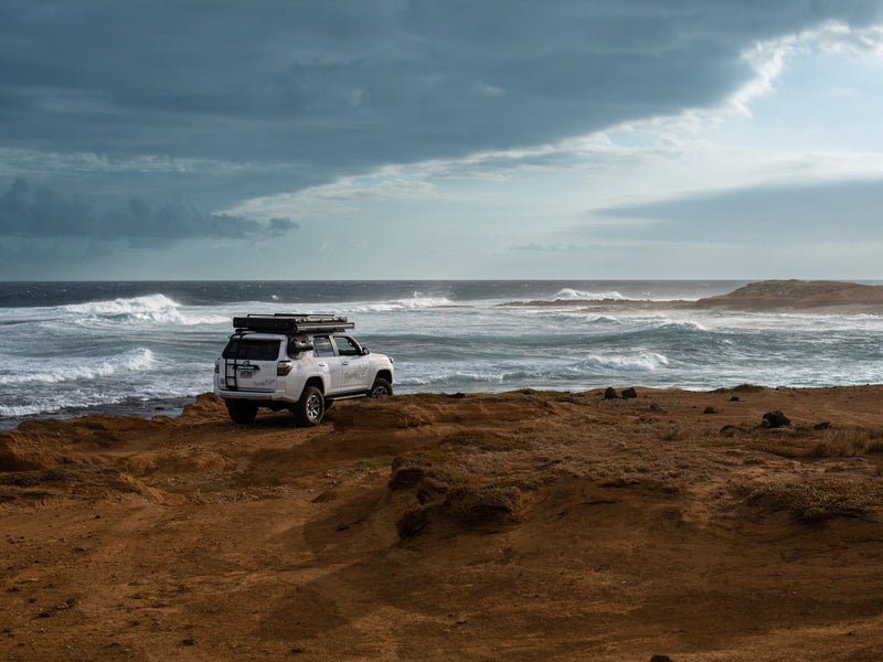  offering direct ocean access and nature views.|Aerial view: A white SUV with a rooftop tent — photo 6