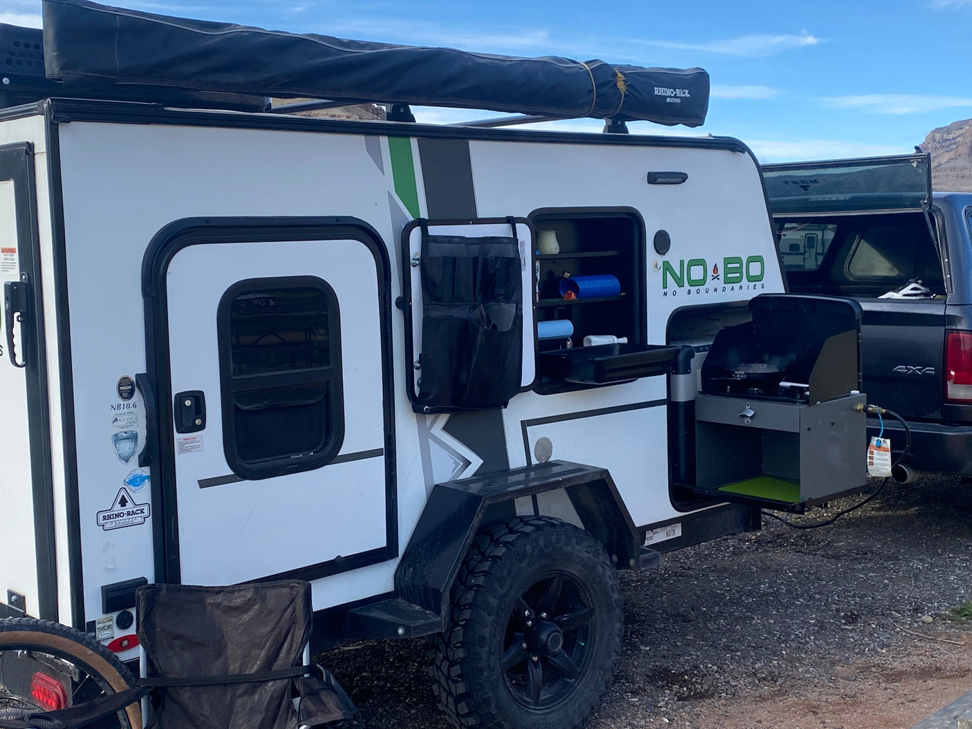 Off-road camper with outdoor kitchen & Rhino-Rack awning. Perfect for your next rv rental adventure!
