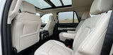 Spacious light-colored SUV interior features panoramic roof & leather seats. Perfect for a luxurious RV rental alternative.