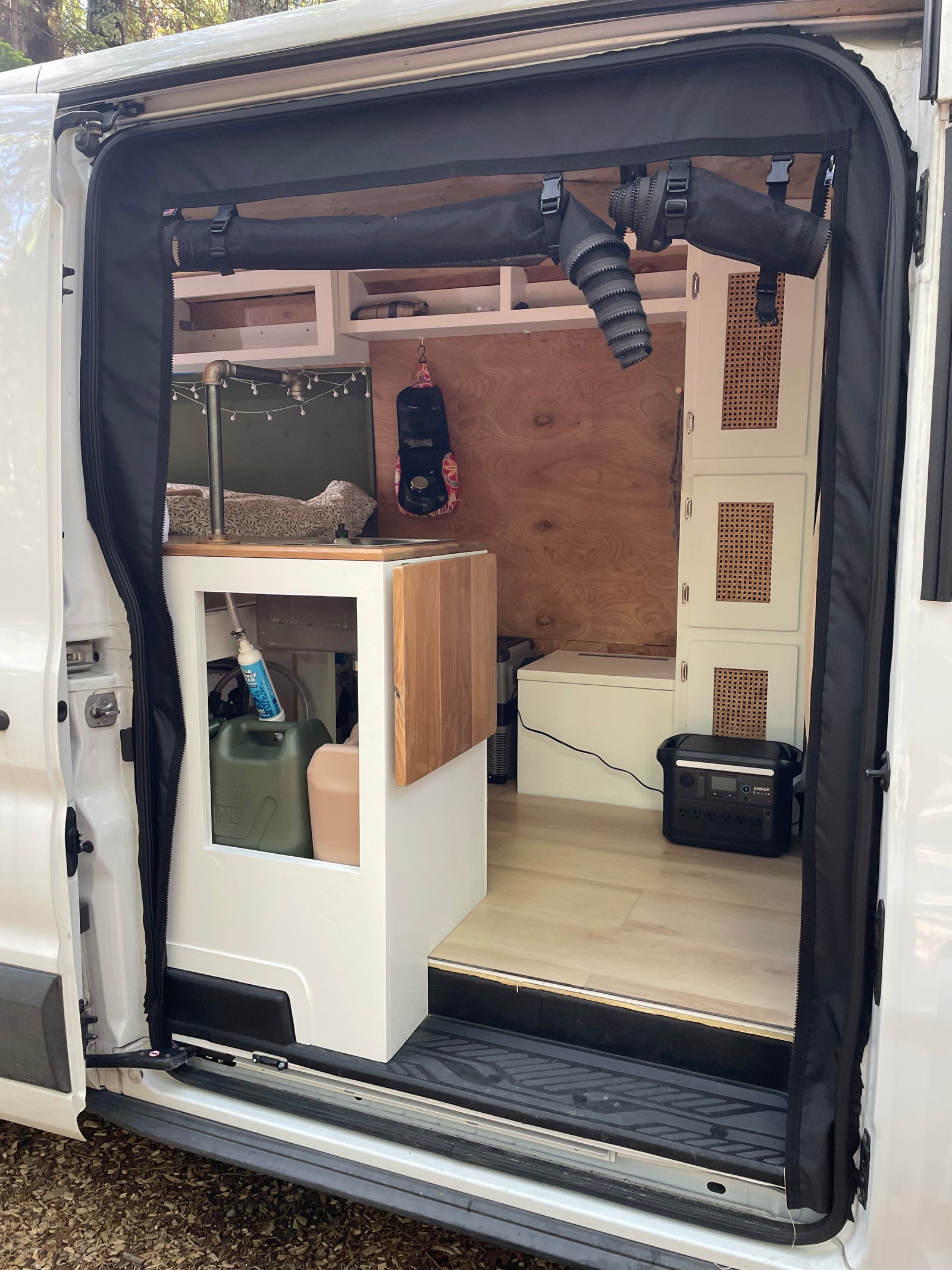 RV rental: Step inside this cozy van conversion with a compact kitchen, water system, and Anker Solix power.