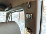 Webasto SmartTemp heater control on the pillar inside an RV rental. Offers warmth, with a snowy outdoor scene visible.