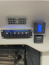RV rental control panel: Dometic & Espar units, switches for lights (dome light on), water pump, DC electric. Heater set 72F.