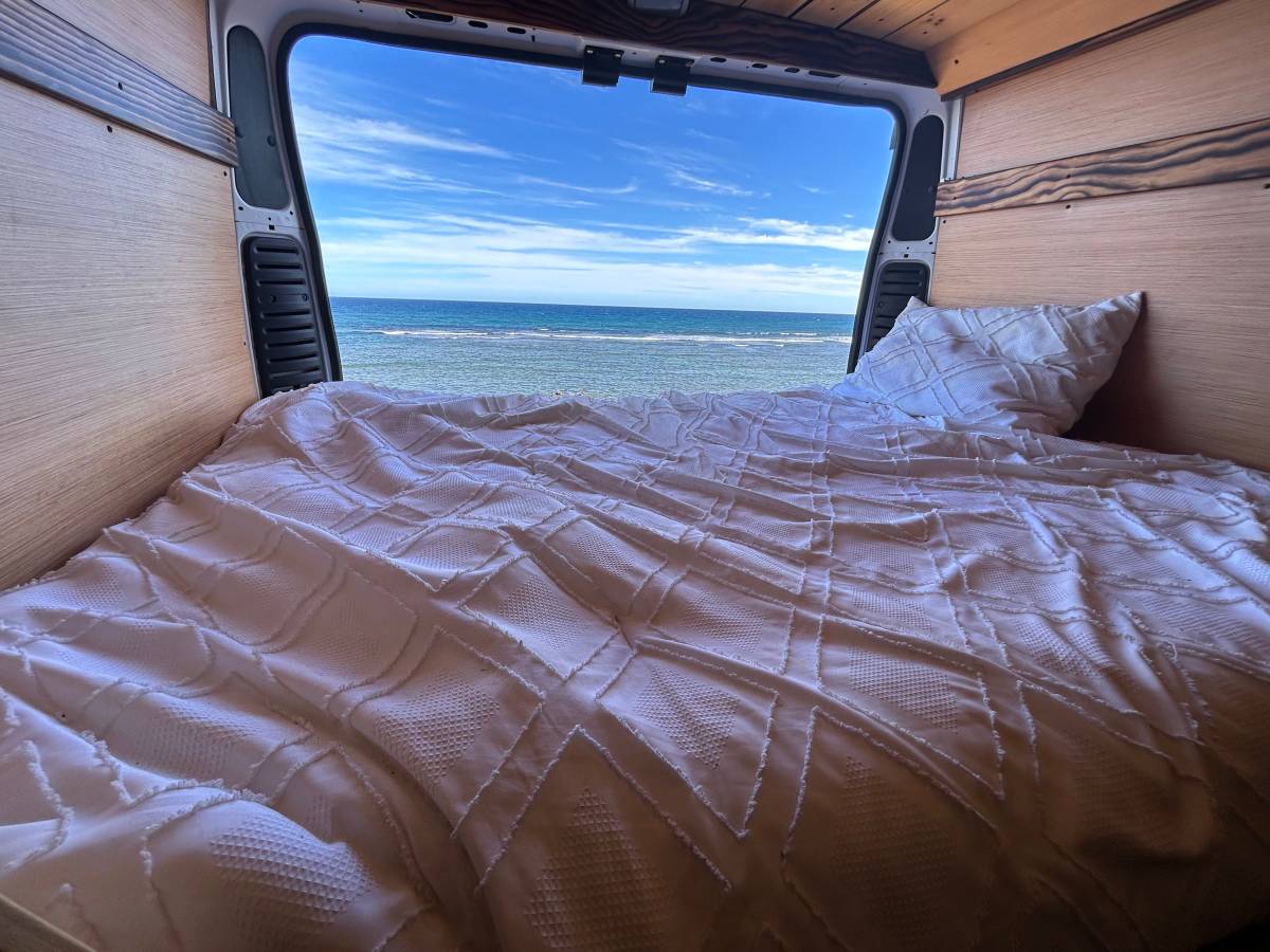  and a comfy bed. Spacious camper van interior.|This white Ram ProMaster 2500 van — photo 5